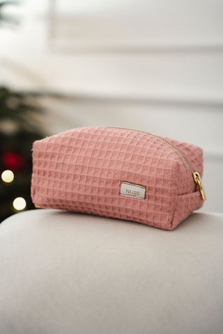 rozā mazs kosmētikas maciņš